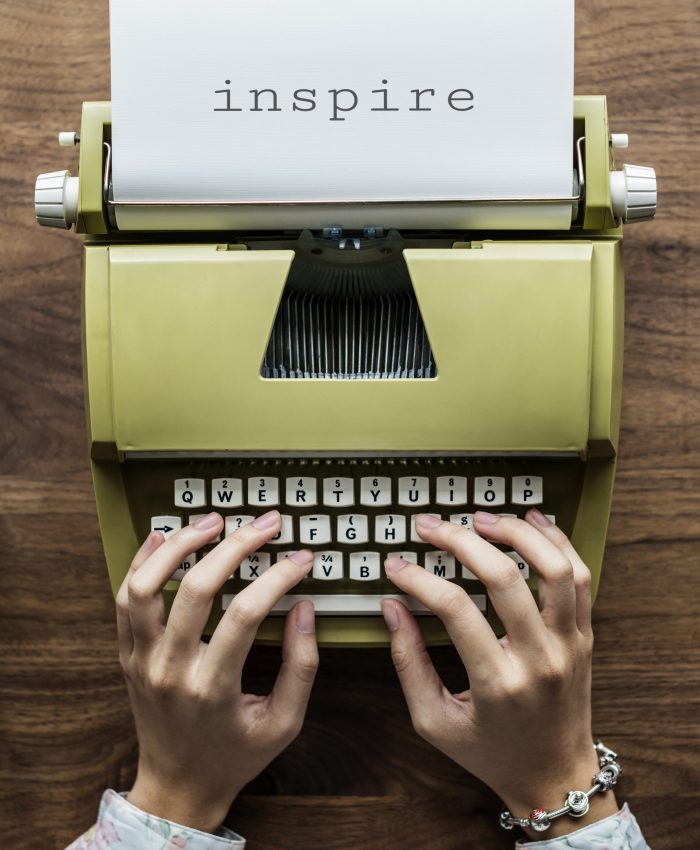 Aerial view of a man typing on a retro typewriter